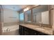 Well-lit bathroom featuring a dual sink vanity with granite countertop, a soaking tub and walk-in shower at 3030 Collin House Dr, Fort Mill, SC 29715