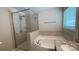Well-lit bathroom with a walk-in shower and a soaking tub with granite counter tops at 3030 Collin House Dr, Fort Mill, SC 29715
