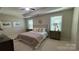 Relaxing bedroom with a tray ceiling, plush bedding, and natural light from the two bright windows at 3030 Collin House Dr, Fort Mill, SC 29715