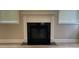 A cozy fireplace with a clean white mantel and black interior at 3030 Collin House Dr, Fort Mill, SC 29715