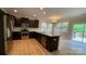 Open-concept kitchen with stainless appliances, dark cabinets, and a granite island at 3030 Collin House Dr, Fort Mill, SC 29715