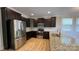 The kitchen features stainless steel appliances, dark wood cabinets, and granite countertops at 3030 Collin House Dr, Fort Mill, SC 29715