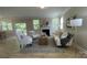 Bright living room boasts ample natural light, neutral tones, and a cozy fireplace at 3030 Collin House Dr, Fort Mill, SC 29715