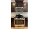 A stainless steel range and microwave in a kitchen with dark cabinets at 3030 Collin House Dr, Fort Mill, SC 29715