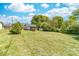 Expansive backyard featuring a shed, porch, and ample green space under a sunny sky at 3117 Fraley Church Rd, Gastonia, NC 28054