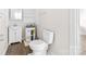 A well-lit bathroom with a toilet and sink next to the water heater at 3117 Fraley Church Rd, Gastonia, NC 28054