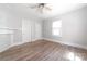 Bright bedroom featuring wood-look floors, two doors and a large window at 3117 Fraley Church Rd, Gastonia, NC 28054