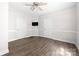 Spacious bedroom featuring wood-look floors, a ceiling fan, and two doors for convenient access at 3117 Fraley Church Rd, Gastonia, NC 28054