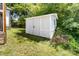 Exterior of a white shed located in the backyard with mature trees and grass at 3117 Fraley Church Rd, Gastonia, NC 28054