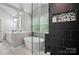 Updated bathroom with soaking tub, shower, black tile accent wall and double vanity at 3908 Brittany Ct, Indian Trail, NC 28079