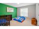 Bright bedroom features twin beds, green accent wall with map, and neutral carpet at 3908 Brittany Ct, Indian Trail, NC 28079