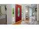 Welcoming entryway featuring a striking red door with decorative glass and sidelights, opening into a spacious, light-filled home at 3908 Brittany Ct, Indian Trail, NC 28079