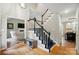 Inviting foyer showcasing a staircase with dark railings, hardwood floors, and access to the living spaces creating an open feel at 3908 Brittany Ct, Indian Trail, NC 28079