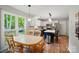 View of the sunny kitchen featuring island seating and a dining area at 3908 Brittany Ct, Indian Trail, NC 28079