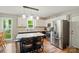 Modern kitchen featuring stainless steel appliances, white cabinetry, and a kitchen island with seating, perfect for entertaining at 3908 Brittany Ct, Indian Trail, NC 28079