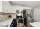 This kitchen features stainless steel appliances and white cabinets at 3908 Brittany Ct, Indian Trail, NC 28079