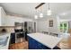 Bright kitchen boasts pendant lights and a center island with bar seating at 3908 Brittany Ct, Indian Trail, NC 28079