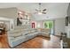 Spacious living room with hardwood floors, vaulted ceilings, a fireplace, and access to the staircase creating an open floor plan at 3908 Brittany Ct, Indian Trail, NC 28079