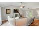 Bright living room featuring a fireplace, vaulted ceiling, and hardwood floors, creating a cozy and inviting atmosphere at 3908 Brittany Ct, Indian Trail, NC 28079