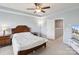 Cozy bedroom featuring a ceiling fan, ensuite bathroom, and access to the upper level at 4011 Black Walnut Way, Indian Land, SC 29707
