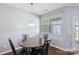 Cozy dining area features a round wood table, stylish chairs, and a window for natural light at 4011 Black Walnut Way, Indian Land, SC 29707