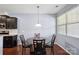 This dining area features a round table, lighting fixture, and is located adjacent to the kitchen at 4011 Black Walnut Way, Indian Land, SC 29707