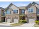 Charming townhome exterior with brick facade, lush landscaping, and private driveways at 4011 Black Walnut Way, Indian Land, SC 29707