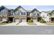 Inviting townhome exterior with brick accents, neat landscaping, and attached garages at 4011 Black Walnut Way, Indian Land, SC 29707