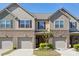 Townhome exterior with brick accents, gray siding, and attached garages at 4011 Black Walnut Way, Indian Land, SC 29707