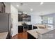Modern kitchen with stainless steel appliances, dark cabinets, and granite countertops at 4011 Black Walnut Way, Indian Land, SC 29707