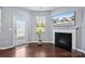 Inviting living room with a fireplace, TV, access to the outdoors, and wood flooring at 4011 Black Walnut Way, Indian Land, SC 29707