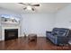 Relaxing living room with plush leather sofa, fireplace, ceiling fan, and polished wood floors at 4011 Black Walnut Way, Indian Land, SC 29707