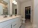 Modern bathroom featuring double vanity, walk-in shower and walk-in closet at 417 Tristram Ln, Charlotte, NC 28205
