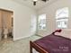 Cozy bedroom with two windows, carpet floors, and attached bath at 417 Tristram Ln, Charlotte, NC 28205