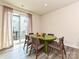 Comfortable dining area with green table, patio access, and stylish curtains at 417 Tristram Ln, Charlotte, NC 28205