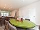 Dining area with green table adjacent to kitchen island with barstools at 417 Tristram Ln, Charlotte, NC 28205