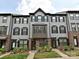 Charming townhome with gray siding, black shutters, brick accents, and well-manicured landscaping at 417 Tristram Ln, Charlotte, NC 28205