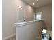 Upstairs hallway with carpet and a door opening to the bedroom at 417 Tristram Ln, Charlotte, NC 28205