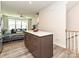 A sleek kitchen island with quartz countertops and a view of the open-concept living area at 417 Tristram Ln, Charlotte, NC 28205