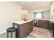 Bright kitchen features an island, modern cabinetry, stainless steel appliances, and hardwood floors at 417 Tristram Ln, Charlotte, NC 28205