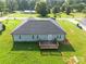 Aerial view of backyard featuring a wooden deck, lush green lawn, and gray vinyl siding at 4193 He Propst Rd, Maiden, NC 28650