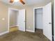 Neutral carpeted bedroom featuring a ceiling fan, closet and doorway to another room at 4193 He Propst Rd, Maiden, NC 28650