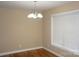 Bright dining room with a classic chandelier, hardwood floors, and a large window at 4193 He Propst Rd, Maiden, NC 28650