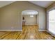 Living room view into dining area with hardwood floors and an arched doorway to kitchen at 4193 He Propst Rd, Maiden, NC 28650