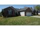 View of the house featuring a brick and siding exterior, a garage, and a lawn at 4193 He Propst Rd, Maiden, NC 28650