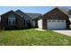 Charming single-story home featuring a brick facade, gray siding, and a well-maintained front yard at 4193 He Propst Rd, Maiden, NC 28650