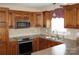 Modern kitchen with stainless steel appliances, wooden cabinets, and tiled backsplash at 4193 He Propst Rd, Maiden, NC 28650