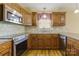 Bright kitchen featuring stainless steel appliances, warm wood cabinets and granite countertops at 4193 He Propst Rd, Maiden, NC 28650