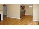 Open-concept living room flowing into the kitchen, featuring hardwood floors and neutral paint at 4193 He Propst Rd, Maiden, NC 28650