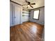 Bedroom with hardwood floors, shelving, and natural light from a window at 5364 Millersville Rd, Taylorsville, NC 28681